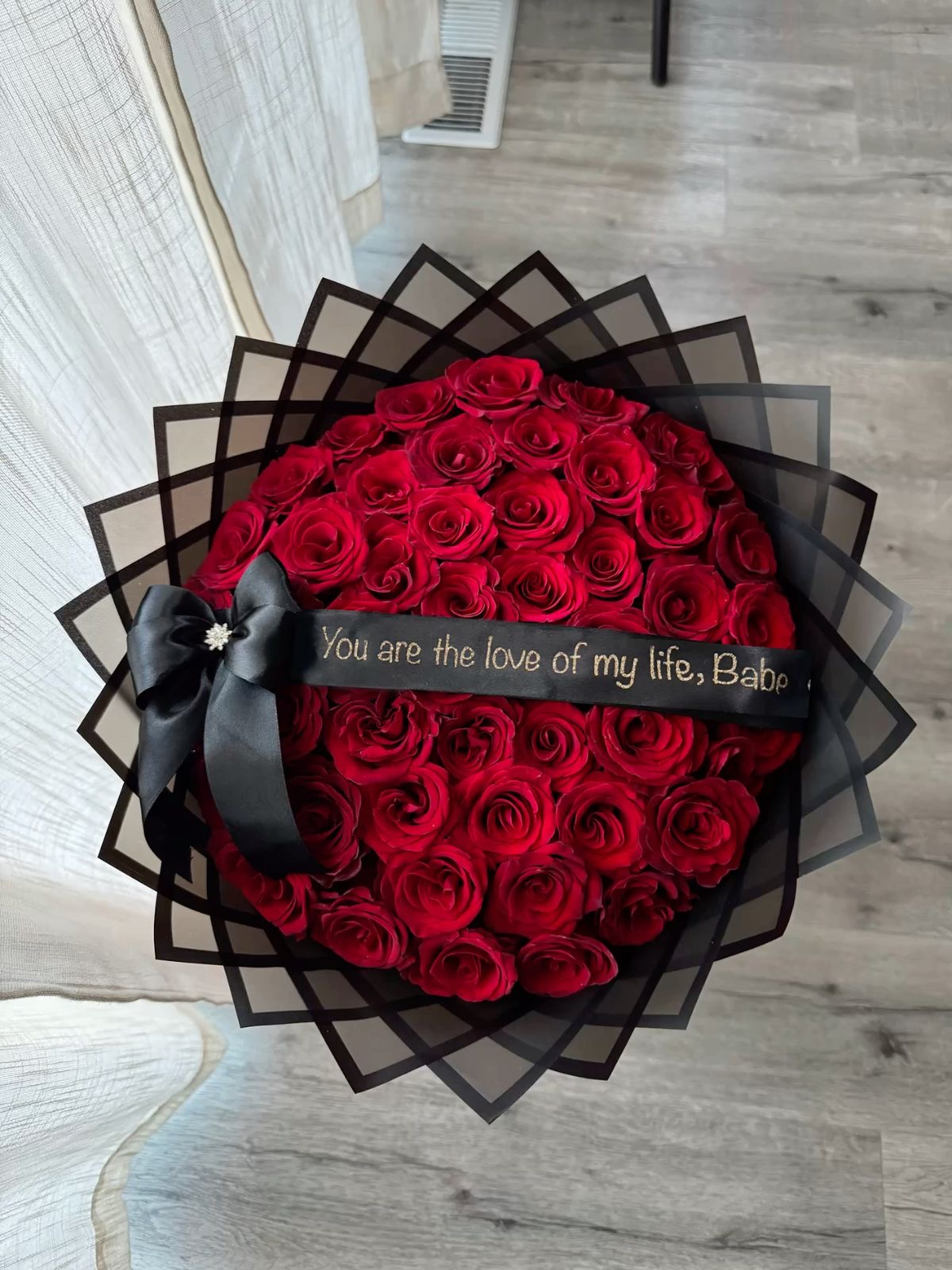 Hand-wrapped bouquet of twenty-five red roses